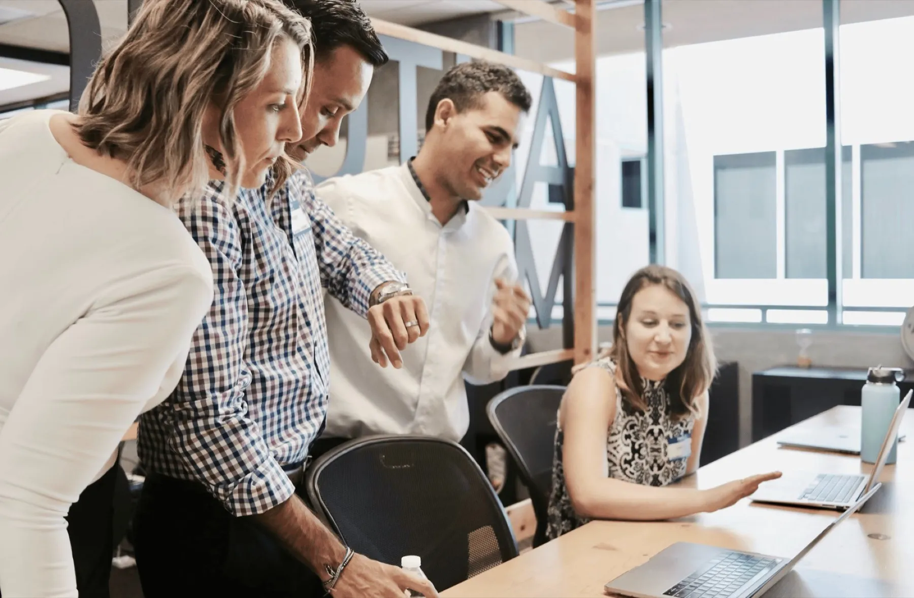 Team reviewing the sales playbook on a laptop